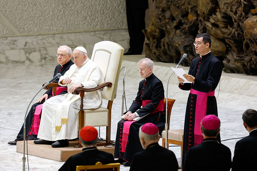Msgr. Filippo Ciampanelli, an official of the Vatican Secretariat of State, read Pope Francis’ general audience talk to visitors gathered in the Paul VI Audience Hall at the Vatican Dec. 6 as the pope continues to recover from bronchitis.