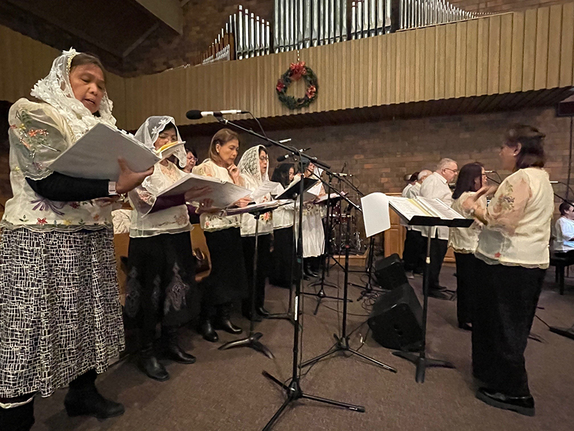 Filipino Catholics sang at the first night of the Simbang Gabi novena Mass on Dec. 14 at St. Joseph Church in Manchester. The nine-day novena of Masses to honor the Blessed Mother, held just before Christmas, is a tradition among Filipino Catholics that traces back to the arrival of Spanish missionaries in the Philippines about 500 years ago.