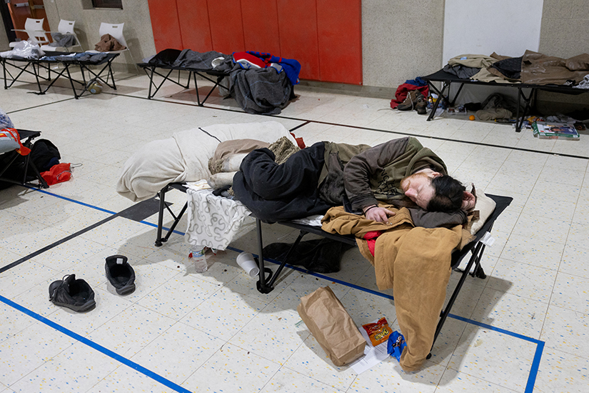 David Pevnick of St. Louis rested on a cot Jan. 16 at an emergency pop-up shelter that Peter & Paul Community Services opened at its headquarters in the Benton Park West neighborhood of St. Louis. “I didn’t really have anywhere else to go,” Pevnick said about the shelter. “Me and my wife lost our house a couple days ago.”