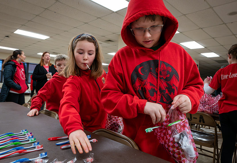 Students from Sts. Joachim and Ann Parish worked to fill blessing bags Jan. 15 at the church. The bags included necessities such as handwarmers and snacks, along with personal touches including notes.