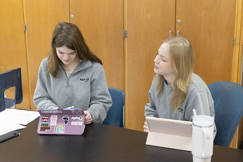 Ella Dressel, a freshman at St. Francis Borgia High School in Washington, worked in a success skills class next to peer mentor Ashley Stika, a senior at the school, Jan. 26. The new peer mentor program at the high school helps create an inclusive environment for students with different learning needs.