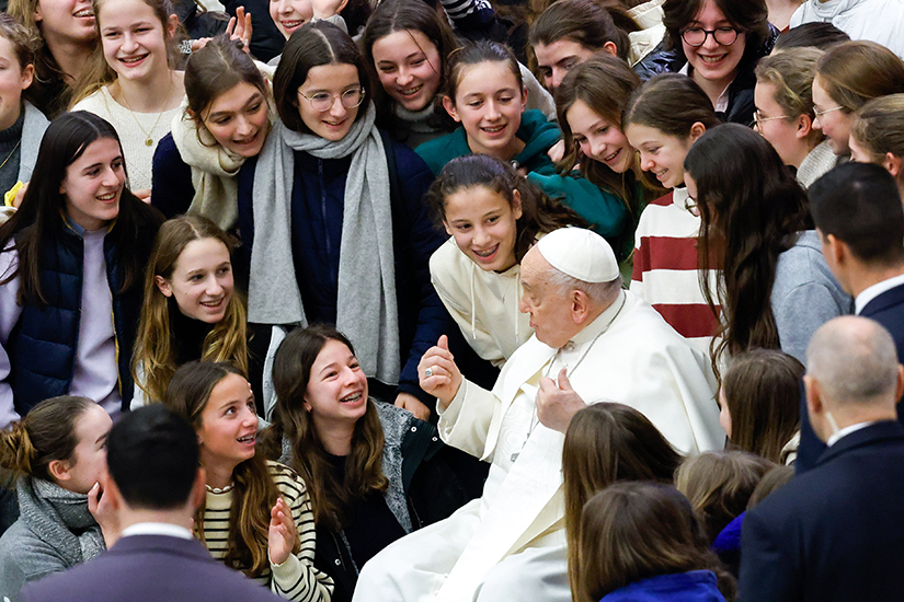 Pope Francis shared a moment with a group of teenagers after his weekly general audience in the Paul VI Audience Hall at the Vatican Jan. 31.
