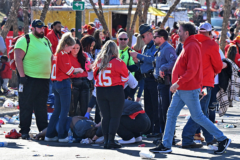 Medics and police tended to an injured person after gunshots were fired in Kansas City, Mo., after the celebration of the Kansas City Chiefs winning Super Bowl LVIII. The shooting at the end of the parade left one dead and more than 20 injured.