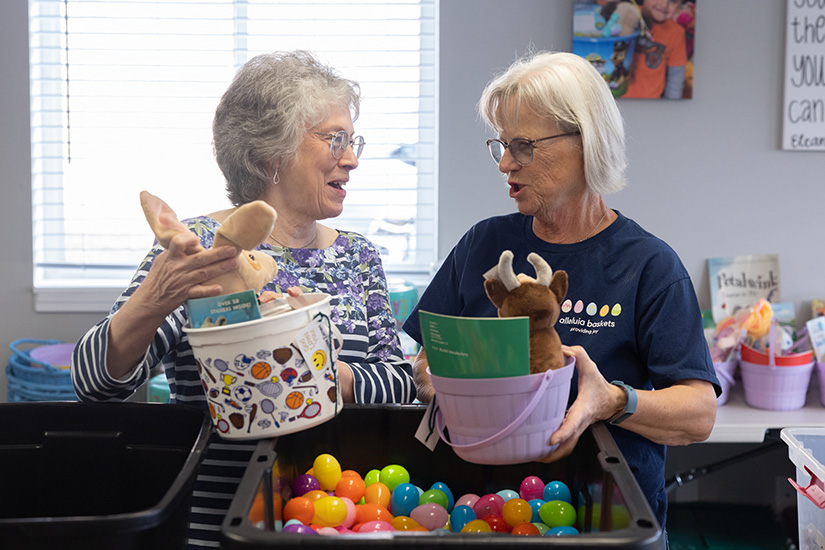 Volunteers Yvonne Solt and Kris Burkemper assembled Alleluia Baskets for 3- to 5-year-olds on Feb. 22 at the headquarters of Alleluia Baskets in O’Fallon. Alleluia Baskets works with about 130 organizations to provide the baskets of goods to children and senior citizens who are underserved in the community.