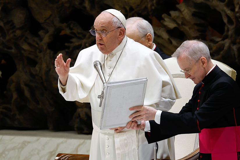 Pope Francis gave his blessing at the end of his weekly general audience in the Paul VI Audience at the Vatican Feb. 28. Because he was feeling ill, the pope had an aide read his catechesis talk at the audience.