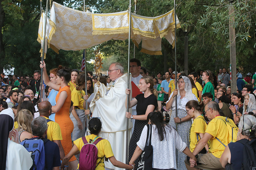Bishop Edward J. Burns of Dallas carried the monstrance in a procession on Aug. 2 during a gathering for U.S. pilgrims at World Youth Day at Quintas das Conchas e dos Lilases Park in Lisbon, Portugal.