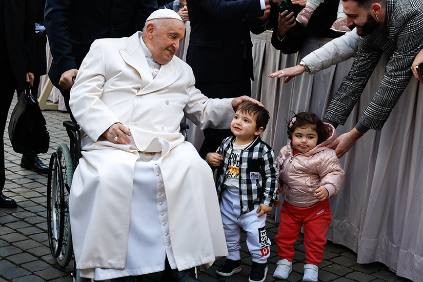 Pope Francis shared a moment with children after his weekly general audience in St. Peter’s Square at the Vatican on March 6.