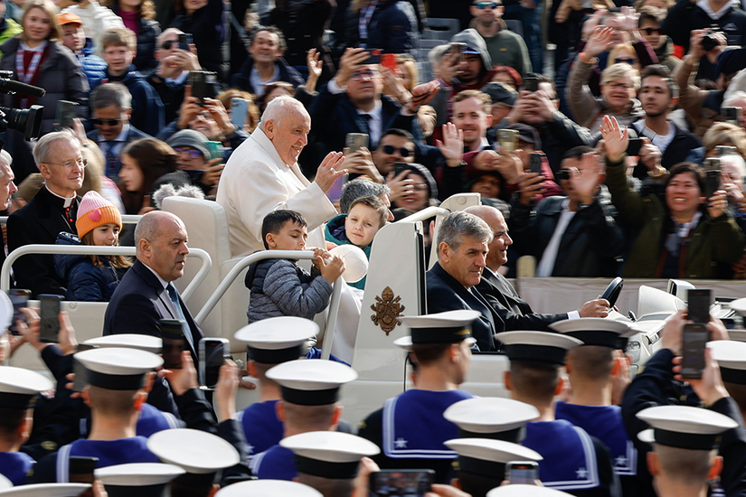 Pope Francis greeted visitors before his weekly general audience in St. Peter’s Square at the Vatican on March 13.