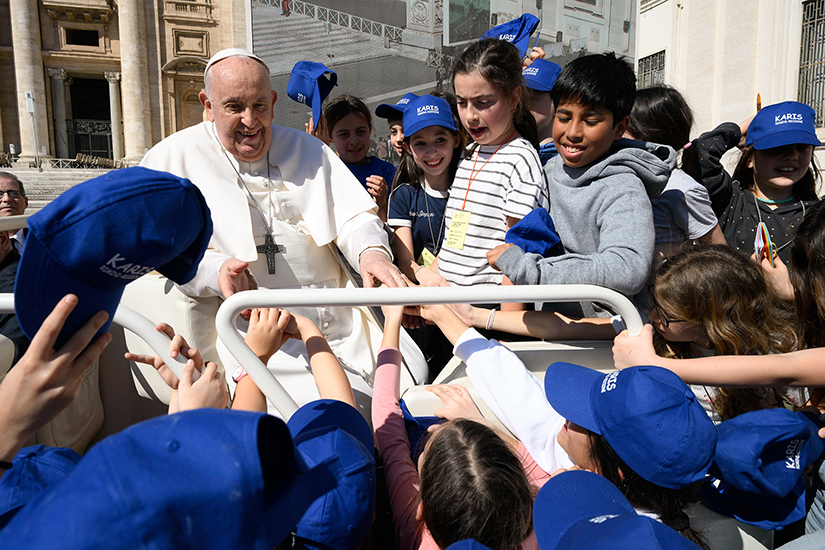 Pope Francis greeted children from the popemobile as he left St. Peter’s Square at the Vatican after his weekly general audience March 20.