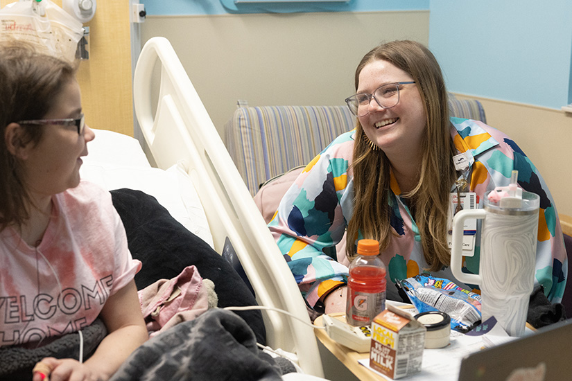 SSM Health Cardinal Glennon Children’s Hospital chaplain Emma Grace Johnson, right, talked with Cardinal Glennon patient Anna Tate on March 6 at the hospital in St. Louis. Emma Grace, who is also the youth minister at St. Margaret of Scotland Parish, said that while it can be tough, there is also a beauty being with patients in the hardest parts of their lives.