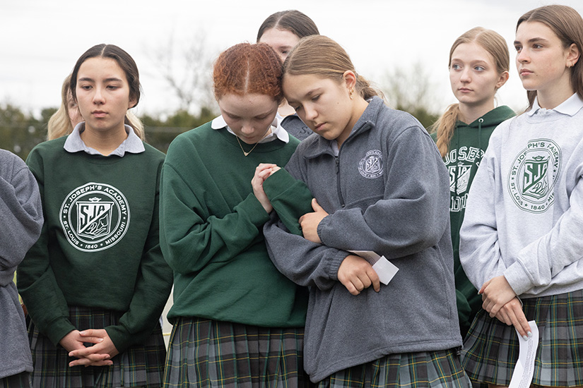 St. Joseph’s Academy freshmen Maddie Miller and Callie Lyng embraced during a vigil outside the Eastern Reception, Diagnostic and Correctional Center where Brian Dorsey was executed April 9 in Bonne Terre. St. Joseph’s Academy freshmen Elise Bruges (hands folded at left) and Laney Albert and Olivia Brand (to the right of Miller and Lyng) also joined the vigil.