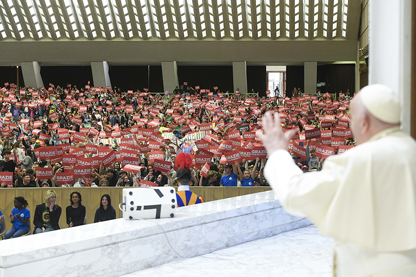Pope Francis waved to about 6,000 Italian schoolchildren involved in the National Network of Schools of Peace, a civic education program, in the Paul VI Audience Hall at the Vatican April 19.