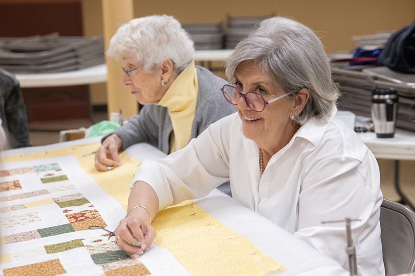 Pat Snyder, a parishioner at Sacred Heart in Valley Park, worked on a quilt April 26 at Sacred Heart Parish in Valley Park. Next to Snyder was June Pokoski. Sacred Heart quilter Mary Dohogne said the group meets weekly and donates most of the quilts to raise money for various parish causes.
