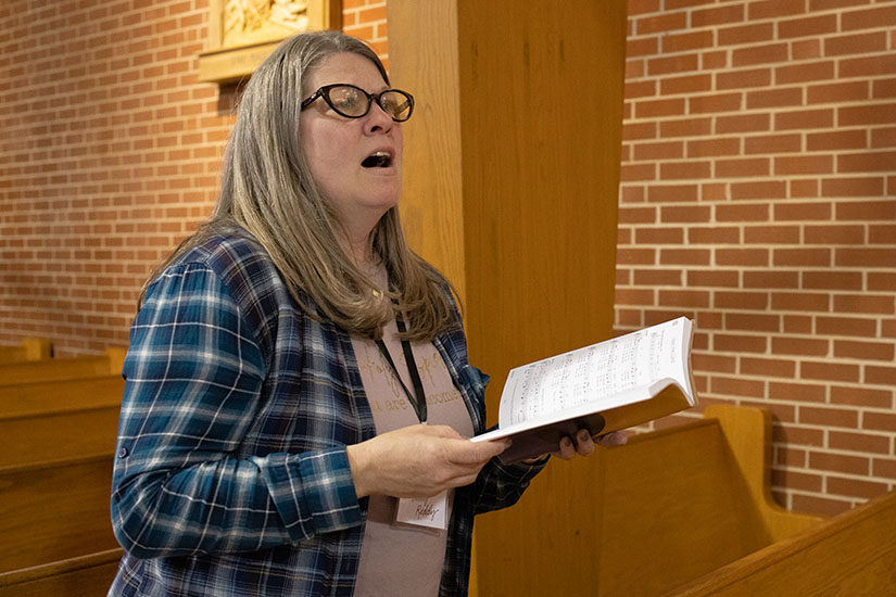 Amy Reddy, a parishioner at St. Ferdinand, sang during a Wednesday Night Service April 24 at St. Ferdinand Parish in Florissant. The weekly gatherings are one way the parish is integrating former parishioners of St. Sabina and St. Martin de Porres, which were subsumed into St. Ferdinand as part of All Things New.
